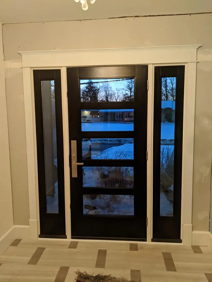 Modern black front door with full-glass sidelites